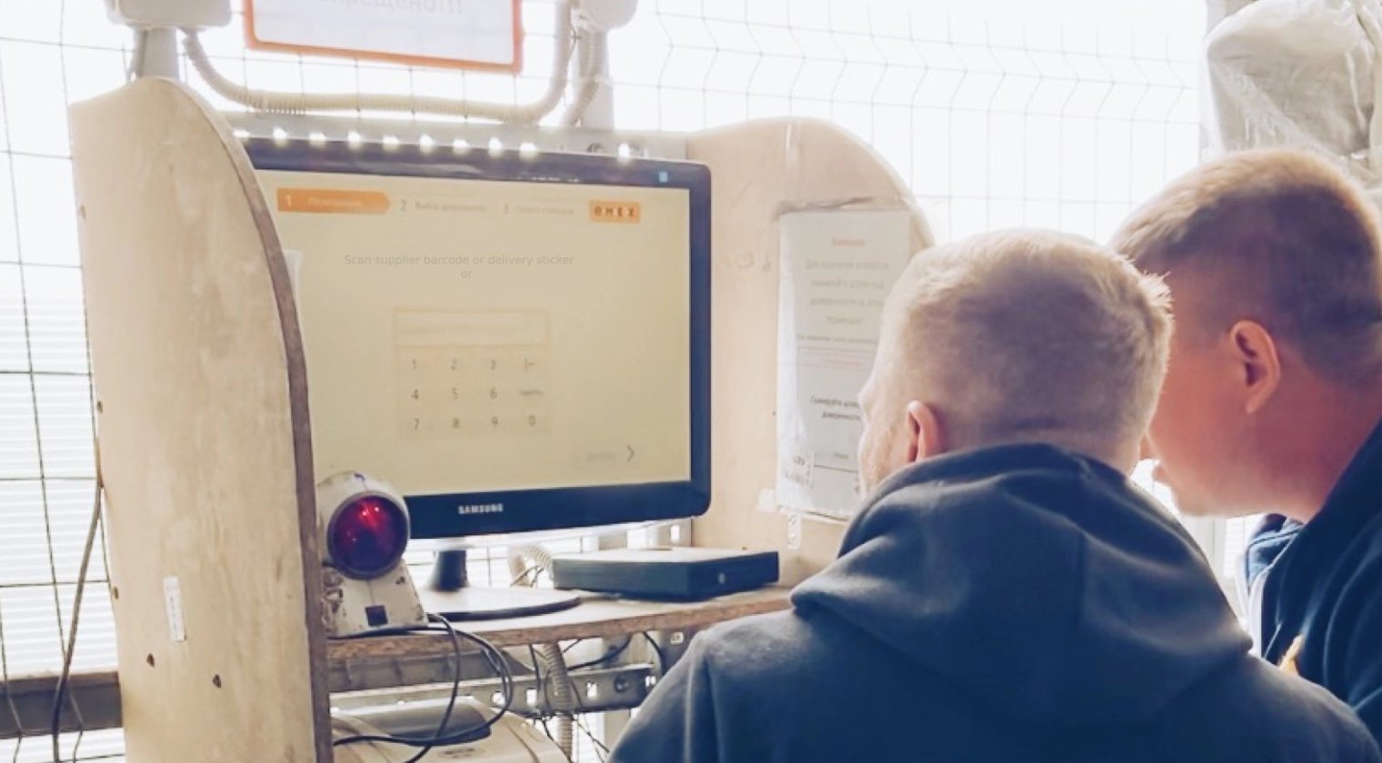 Warehouse workers at an Emex scanning terminal